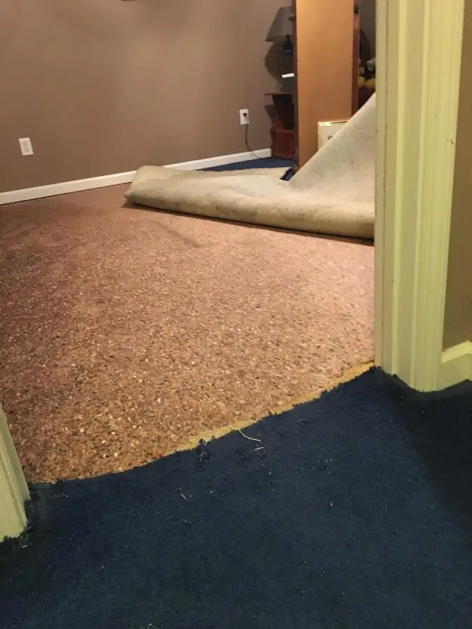 Carpet pad removal revealing water damage during Drying & Dehumidification in Algona