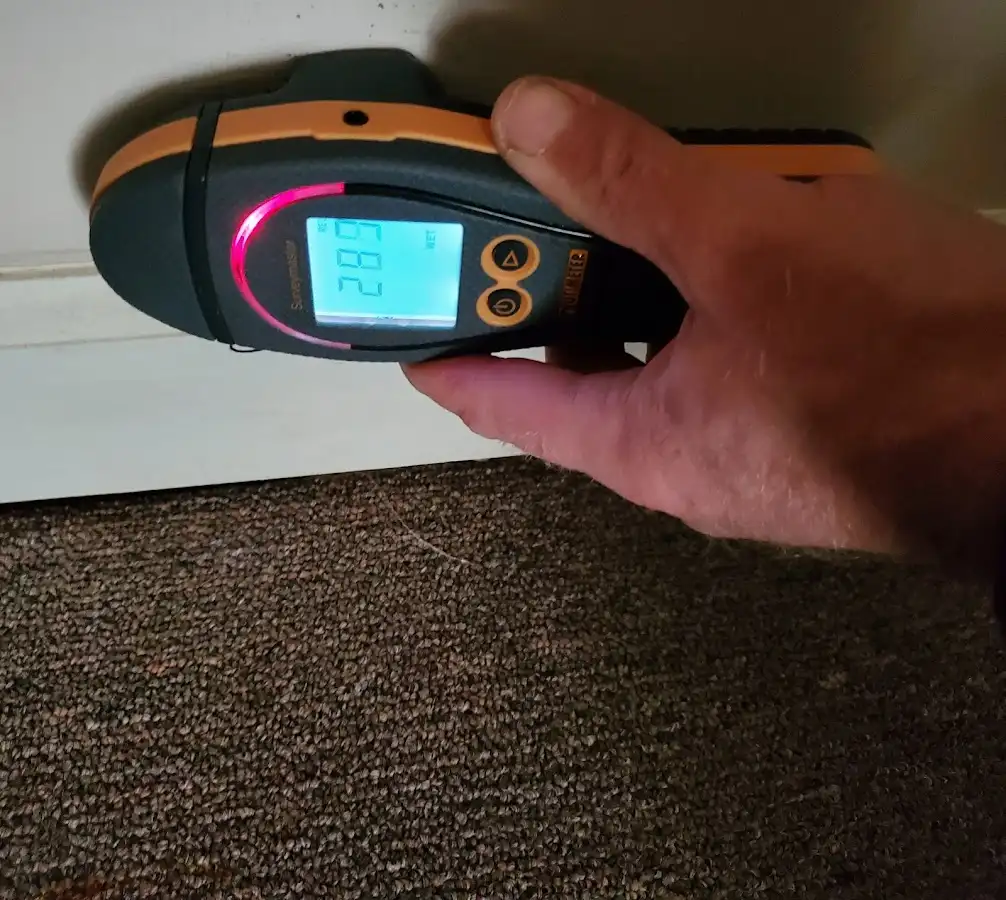 Moisture detection at baseboard during Storm Damage Restoration in Algona